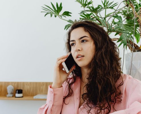 Woman on the phone to Indigo Finance to conduct a mortgage review