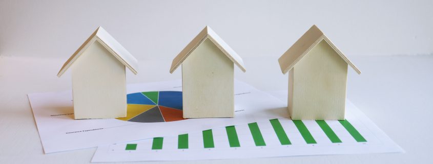 Three wooden houses, and the figures that link them together.